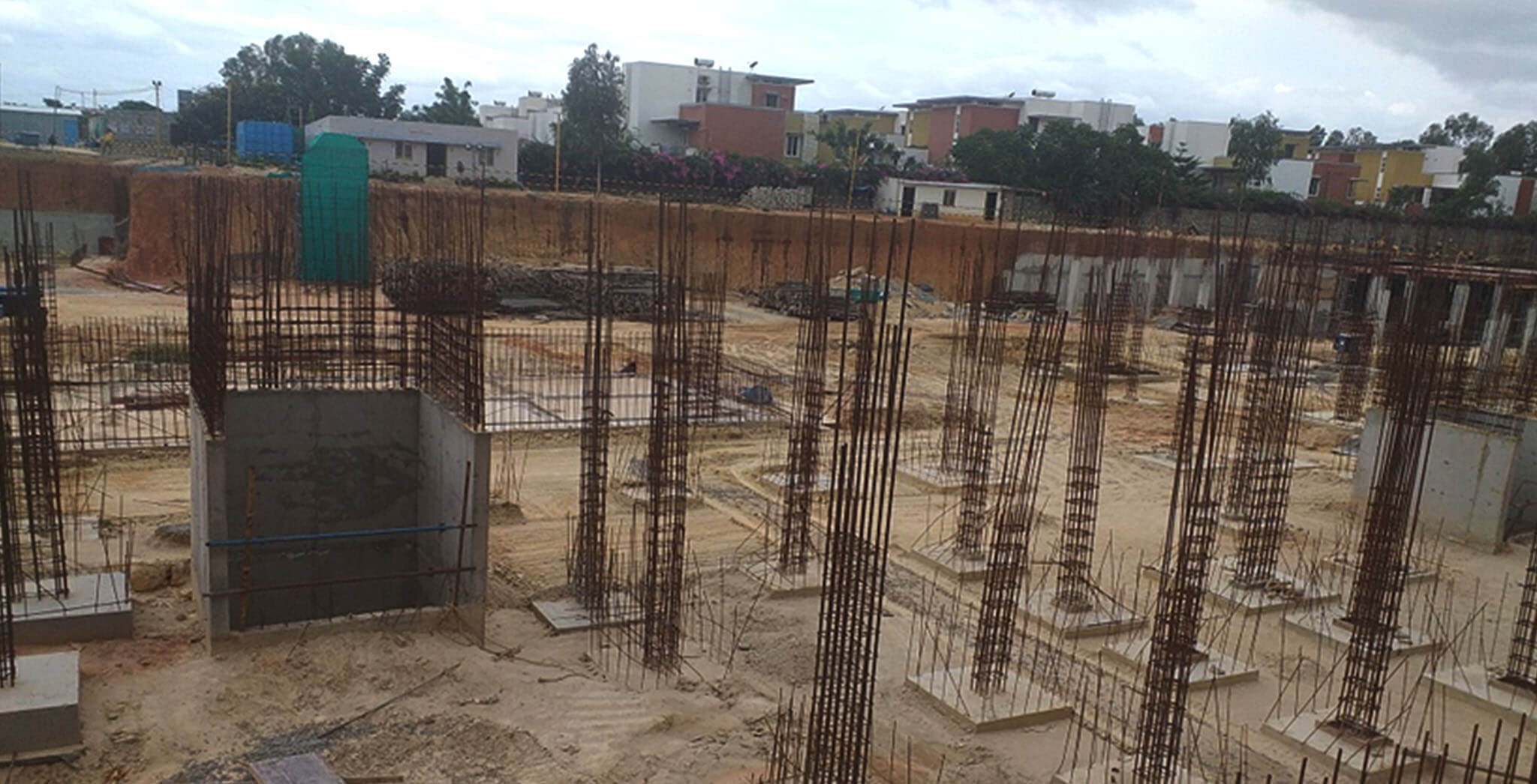 Aug 2019 - North side view: Q and R Block Footings completed, grade slab PCC and columns under progress.