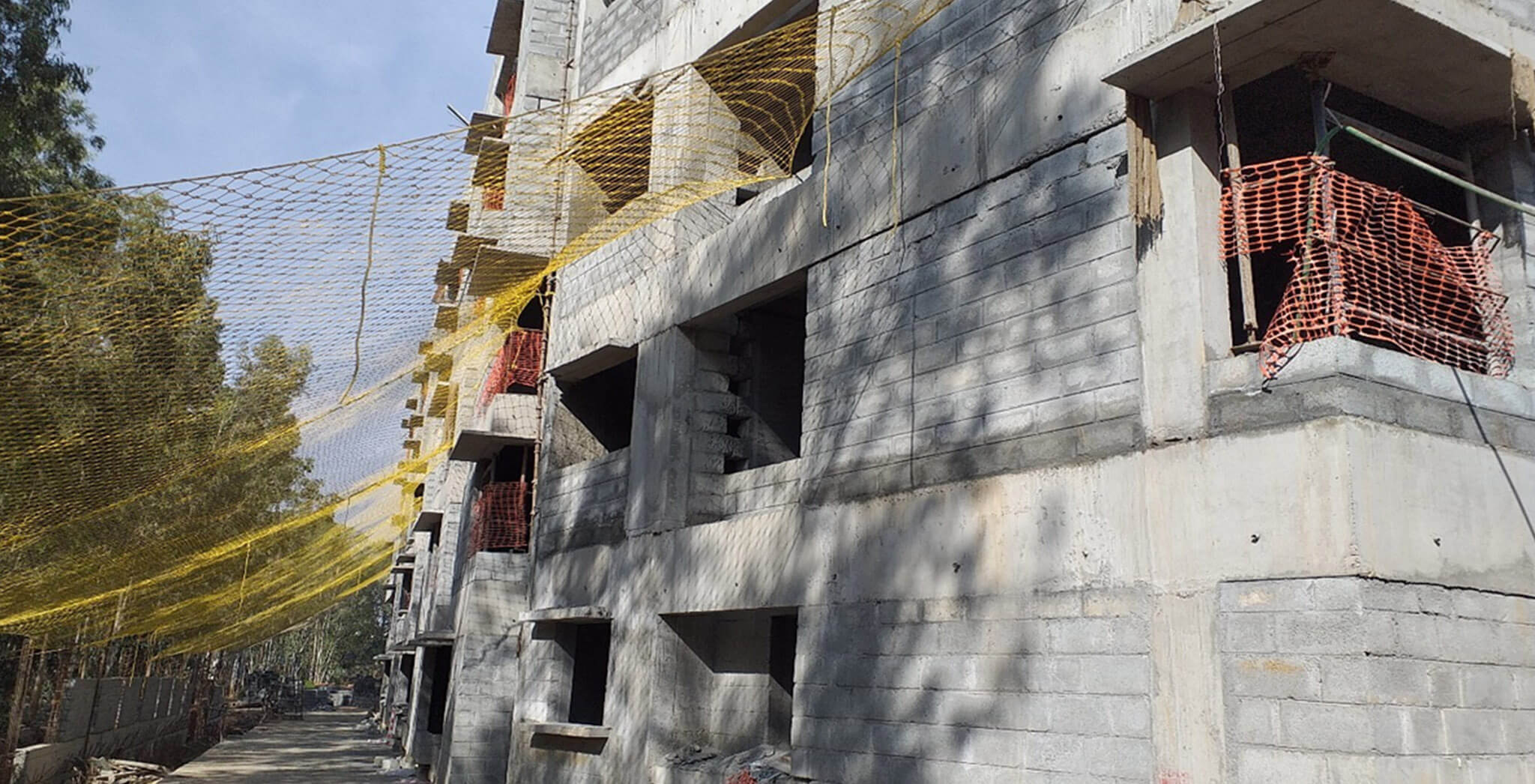 Mar 2020 - West side view: L & M Blocks: Block work completed, internal plastering works in progress; M Block—Plumbing works in progress