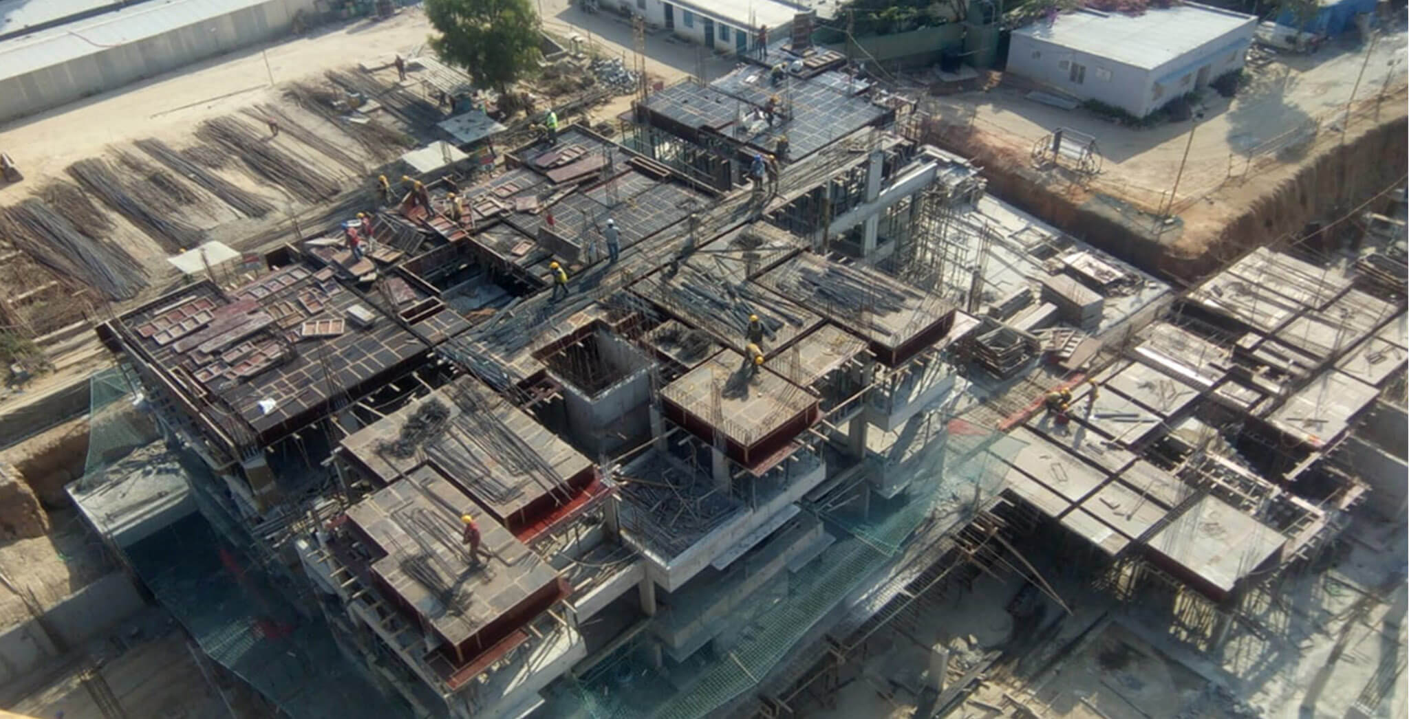 Mar 2020 - South side view: F Block—GF shuttering and reinforcement works in progress; E Block—3rd floor concreting in progress