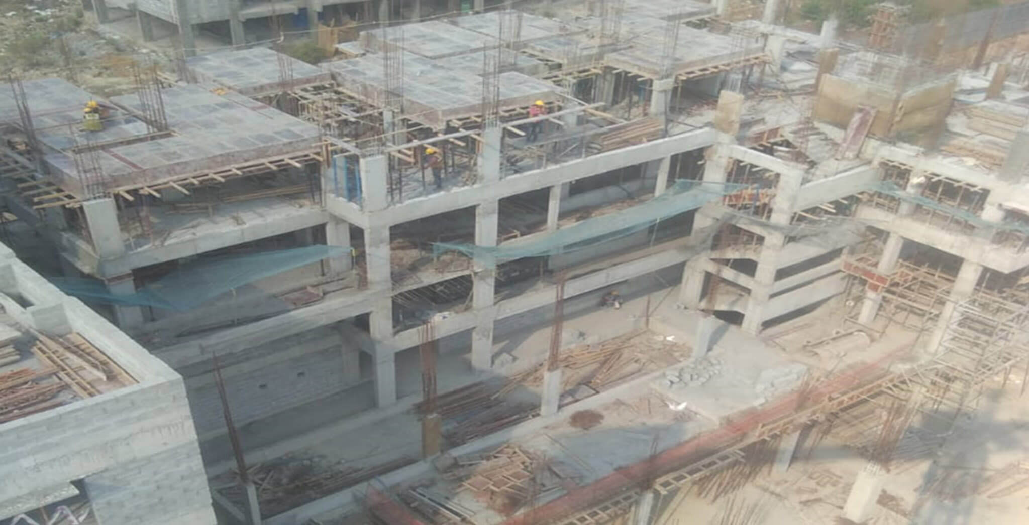 Mar 2020 - North side view: Q Block—4th floor shuttering and reinforcement works in progress; Q Block—1st floor block work in progress