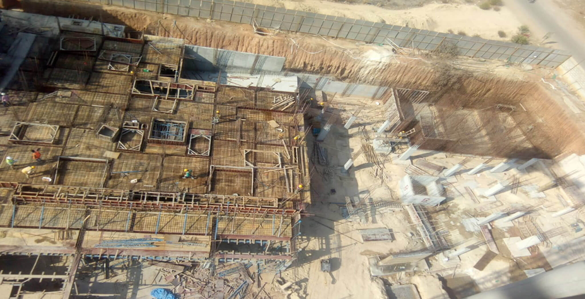 Mar 2020 - North side view: A Block—GF shuttering and rebar works completed, concreting works in progress; UG Sump wall shuttering works in progress; B Block—Foundation works in progress