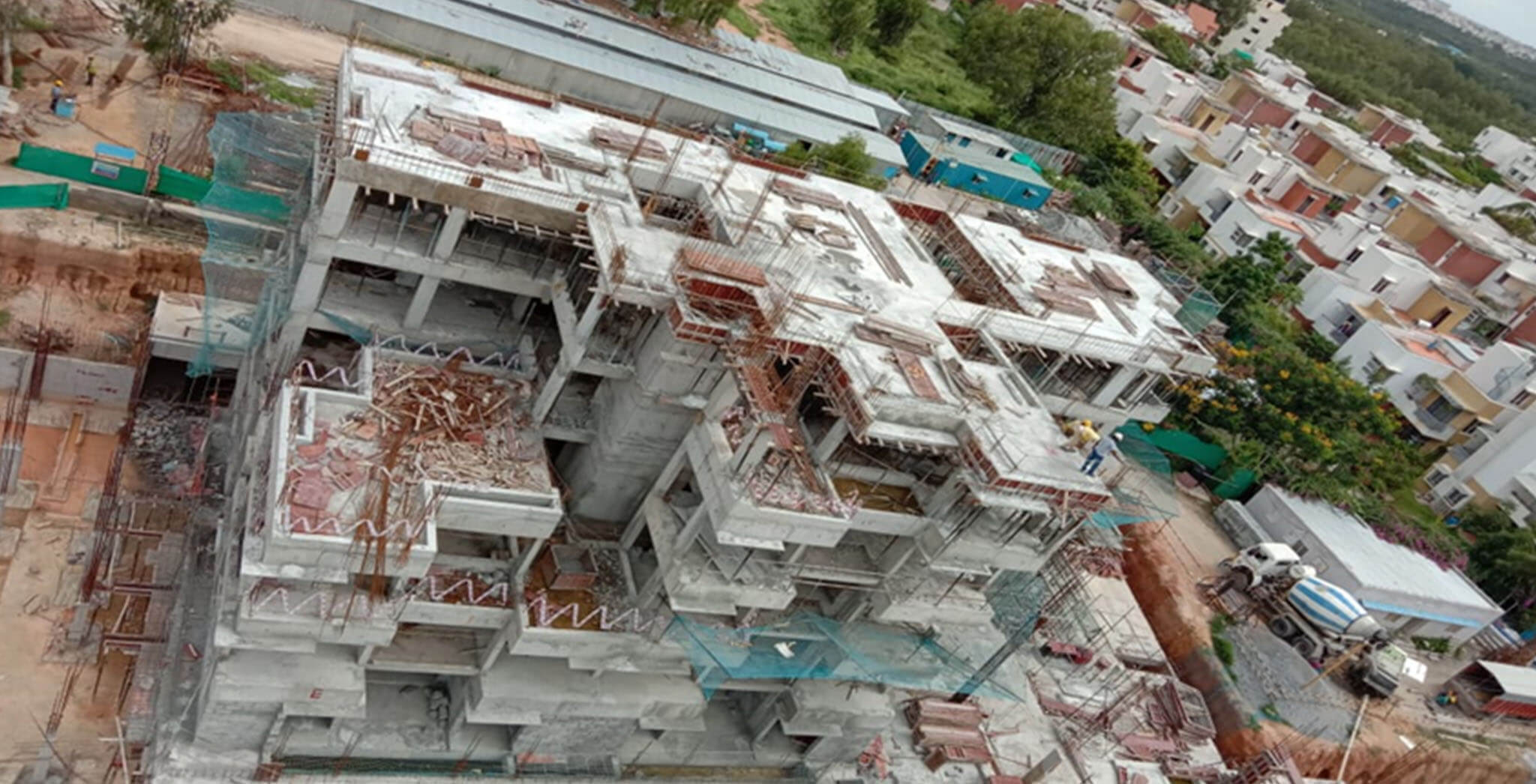 Jul 2020 - South side view: E Block—Terrace floor slab completed; Block work in first floor level in progress.