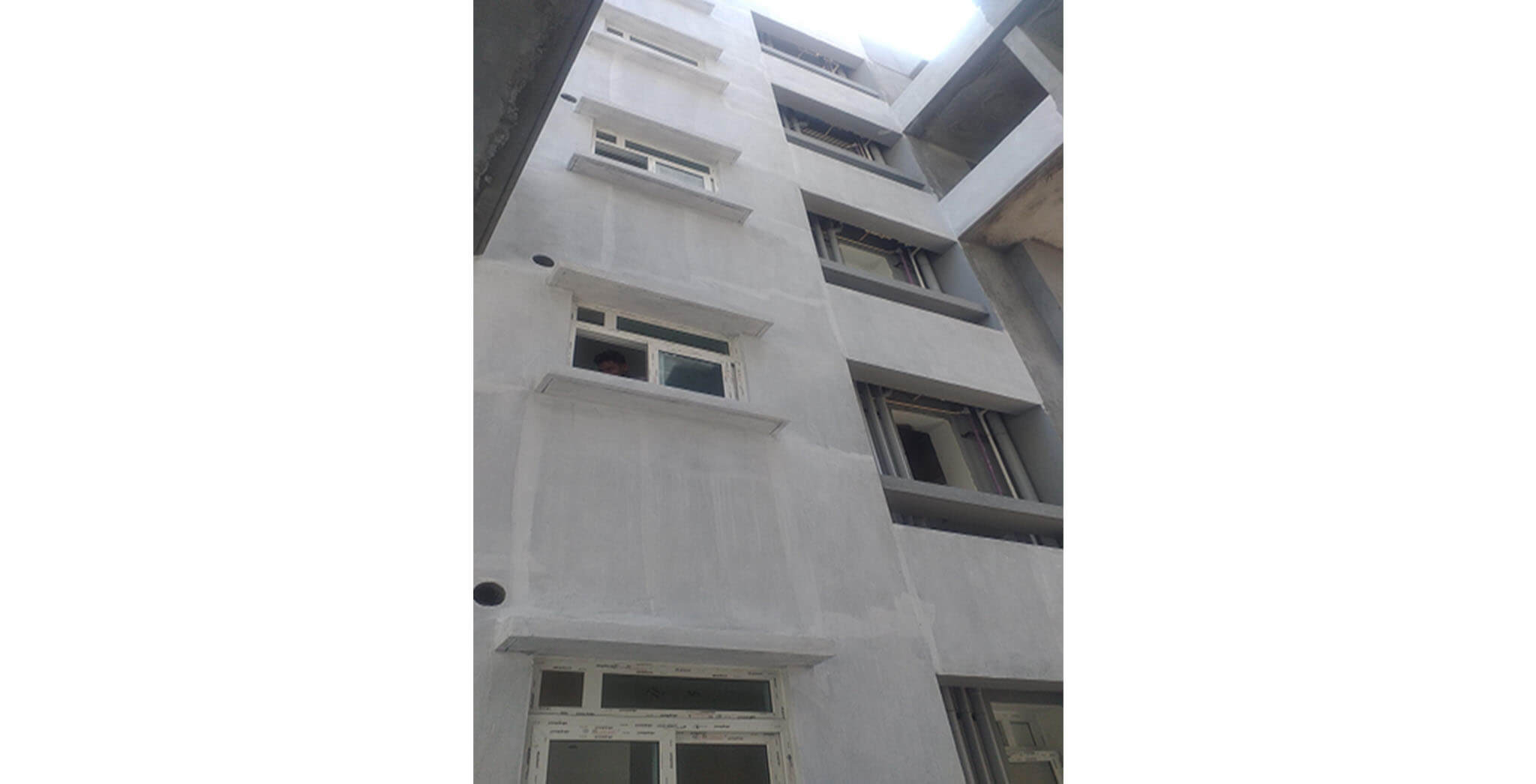 Feb 2021 - Podium side view: K Block—External wall primer work-in-progress