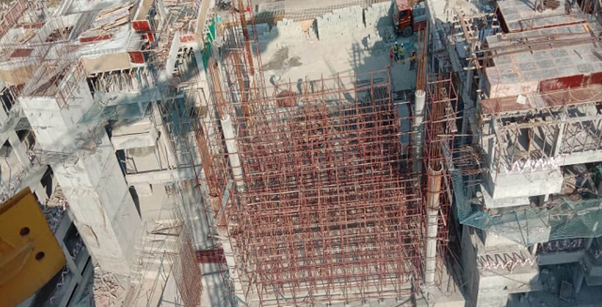 Feb 2021 - East side view: B Block—Terrace floor slab completed; C Block—Gym area shuttering work-in-progress